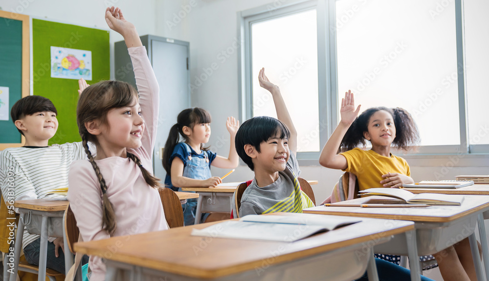 Pupil boy active learn with teacher in classroom at elementary school. Student boy girl studying in primary school. Many hands of volunteers during class room raise hand answer question banner Pupil boy active learn with teacher in classroom at elementary school. Student boy girl studying in primary school. Many hands of volunteers during class room raise hand answer question banner