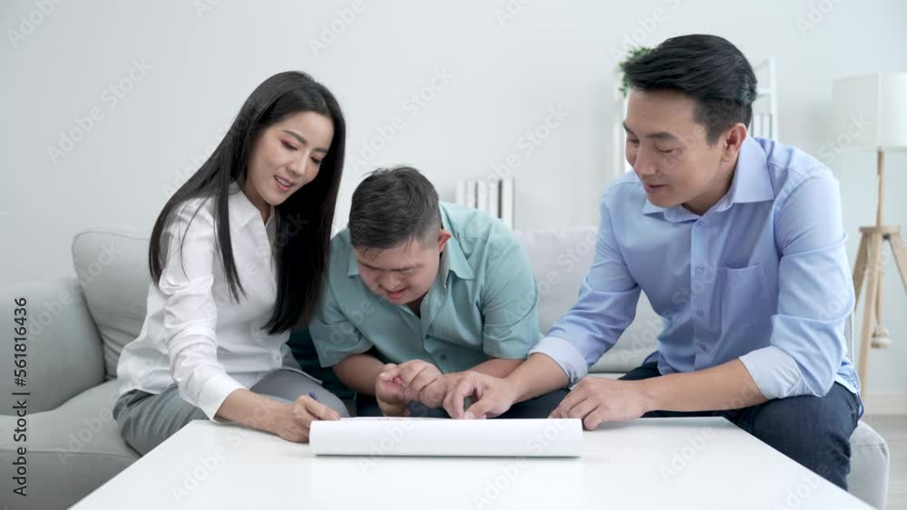 Asian parents drawing with son in living room at home. Asian parents drawing with son in living room at home.