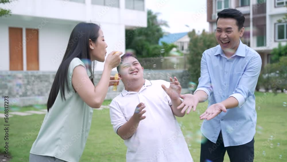Happy Asian family playing with son in backyard. Happy Asian family playing with son in backyard.