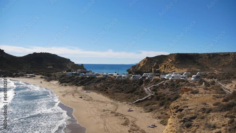 A Seashore With A Beach, Hills And A Group Of Campervans A Seashore With A Beach, Hills And A Group Of Campervans