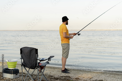 Young men fishing in summer and relaxing while enjoying hobby