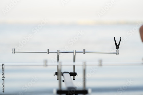 Equipment for fishing stand for fishing rods on the shore against the background of the summer sky. Fishing and hobby concept