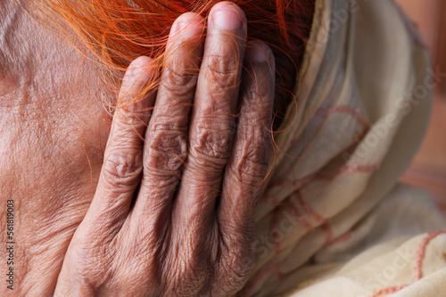 senior women having ear pain touching his painful ear , © Towfiqu Barbhuiya 