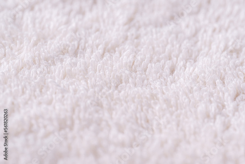 Closeup of a white towel. Texture of white soft terry blanket textile.