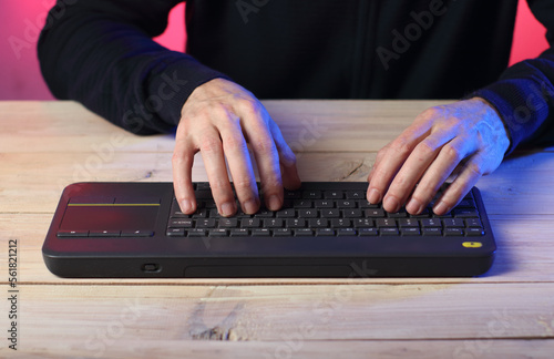 person typing on keyboard from tv
