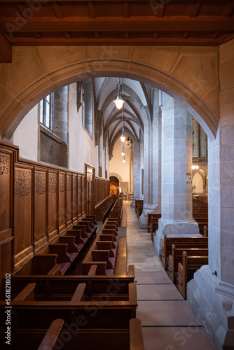 Empty wooden pews or chairs inside Gothic  medieval church in Europe. Wide angle  no people