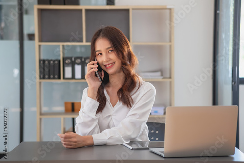 Marketing, Financial, Accounting, Planning, businesswomen uses a mobile phone to contact a customer to inform her of the company is business partnership.