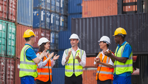 Employees applauding manager during meeting in a factory. worker teamwork encouraging team. International shipping import Export shipyard business concept. Industrial and working in container yard