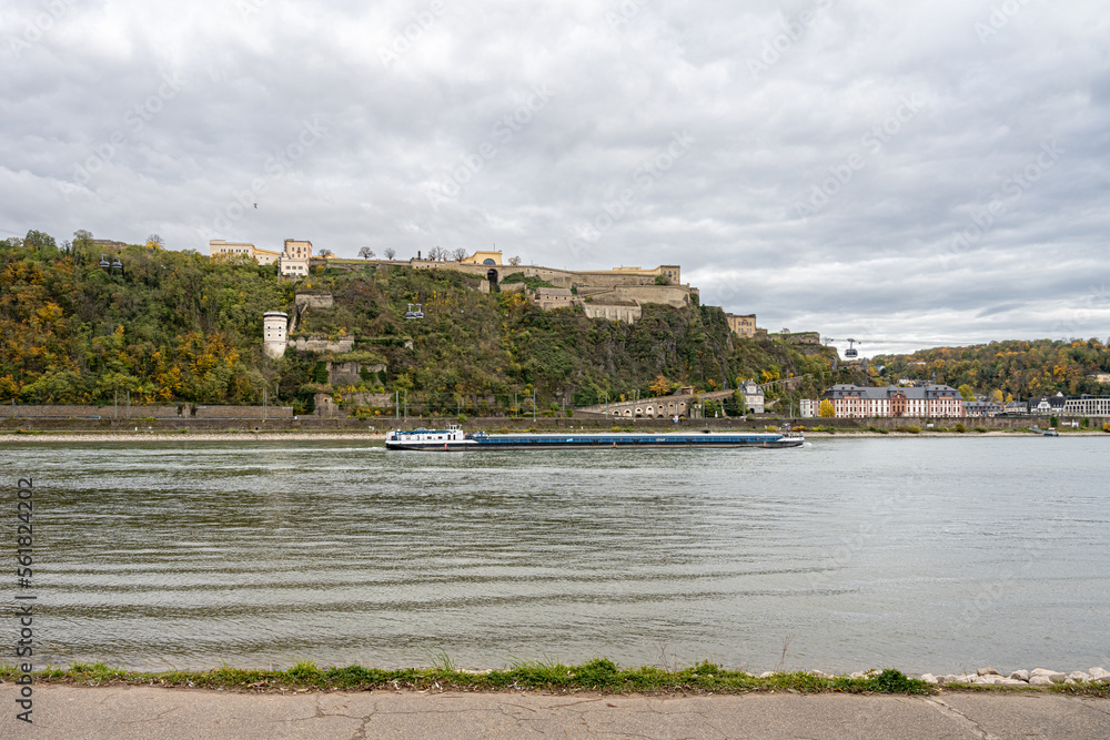 German corner, Koblenz were rivers Rhein and Mosel meet. A river barge in the foreground with the Ehrenbreitstein castle in the background