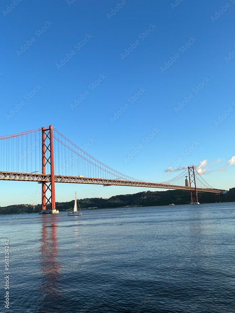 The April 25 Bridge is a suspension bridge connecting Lisbon on the north (right) and Almada on the south (left) bank of the Tagus River.