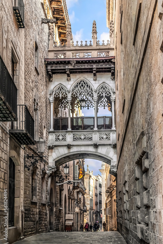 Pont del Bisbe or Bishop’s Bridge is a Neo-Gothic style bridge that crosses street by Joan Rubio i Bellver in Barcelona, Spain, 1928. Narrow medieval street in the Gothic Quarter of Barcelona