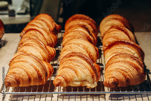 Close-up of fresh and beautiful croissants in a bakery showcase.