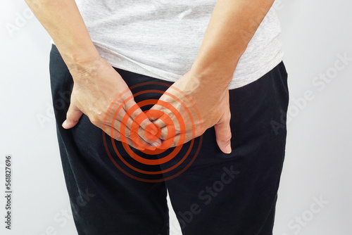 Woman hands touching her buttocks area suffering from pain. Health care and medical concept.