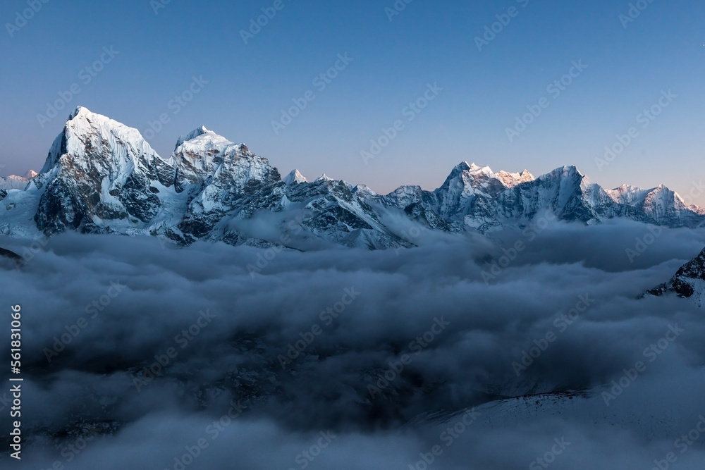 Mountain ridge in Himalayas at dusk. High peaks in cloud river in Nepal.