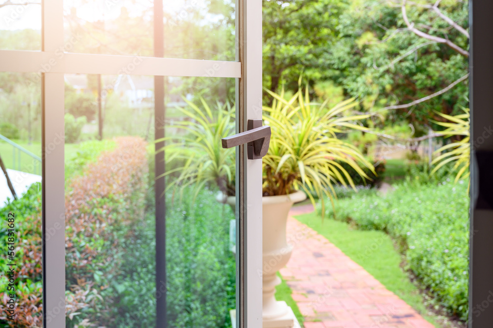 aluminium window with latch handle open with garden on background. aluminium window with latch handle open with garden on background.