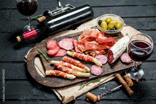 Antipasto background.Traditional Italian appetizers with red wine.
