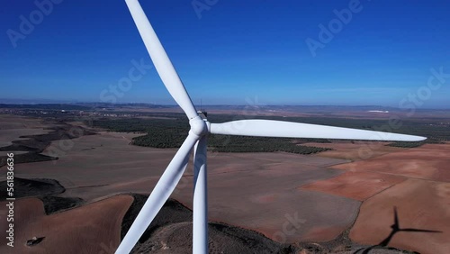 wind turbine seen with drone from above with olives in background photo