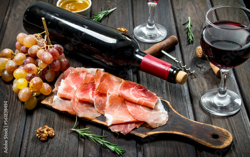 Traditional Spanish ham with grapes and red wine.