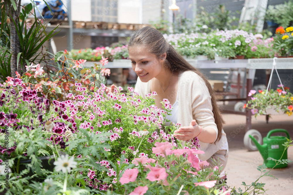 young lovely saleswoman in flower shop