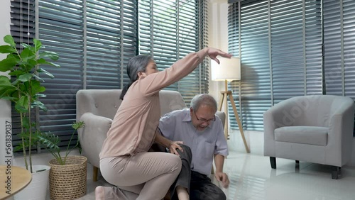 Elderly grandfather had an accident and fell down in the living room, Grandma rushed to help Grandpa.