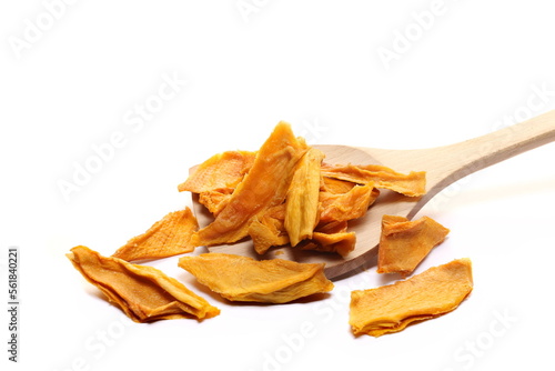 Dried mango slices in wooden spoon isolated on white, side view