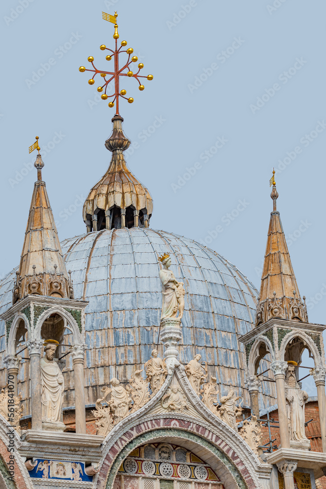 Naklejka premium View over decoration elements at roofs and cupolas of Basilica San Marco in Venice, Italy, at sunny day and deep blue sky.