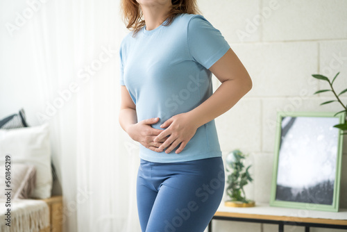 Obraz na płótnie Menstrual pain, woman with stomachache suffering from pms at home, endometriosis