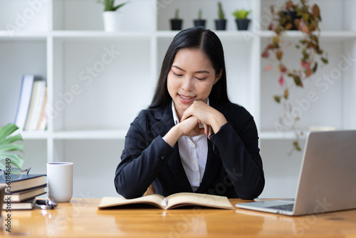 Portrait of beautiful asian businesswoman working with laptop in office.