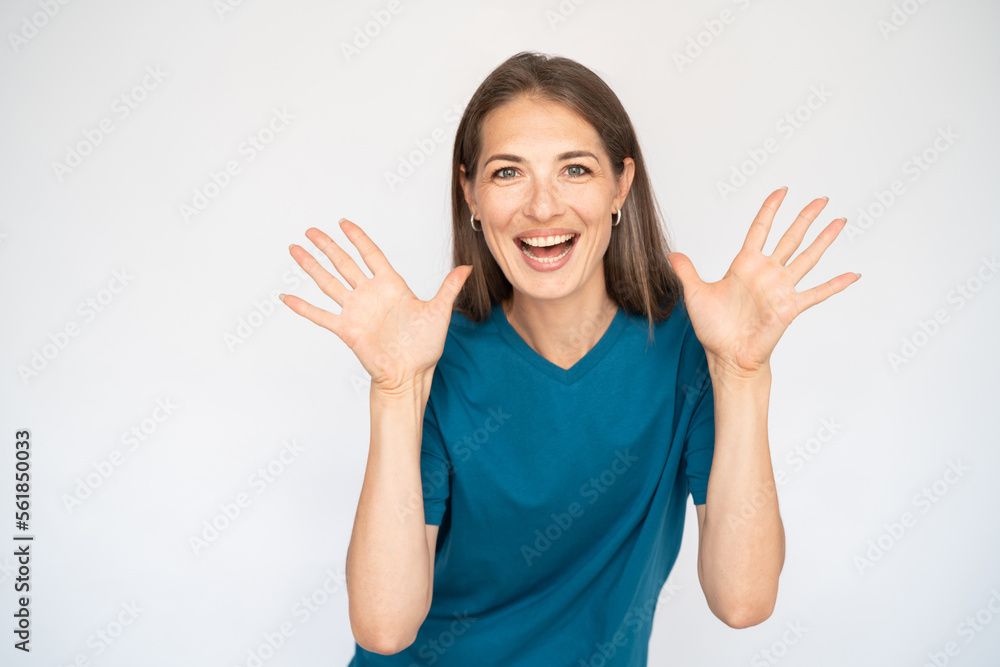 Cheerful Caucasian woman with open palms. Portrait of happy young female model with brown hair in blue T-shirt looking at camera, smiling, receiving good news or gift. Surprise concept Cheerful Caucasian woman with open palms. Portrait of happy young female model with brown hair in blue T-shirt looking at camera, smiling, receiving good news or gift. Surprise concept