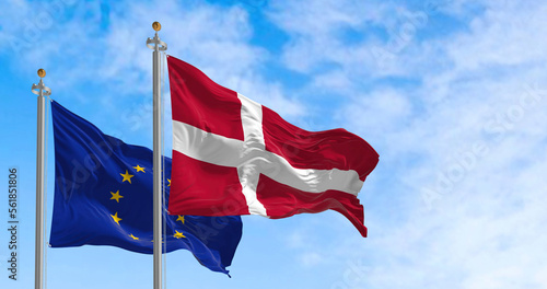 The flags of Denmark and the European Union waving together on a clear day