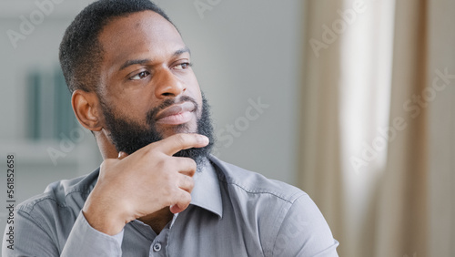 Fotografia Close up thoughtful pensive ethnic bearded African American man thinking busines