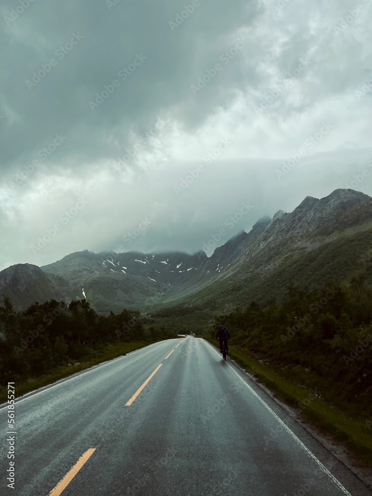 Empty highway in mountains, stormy weather, dark clouds Empty highway in mountains, stormy weather, dark clouds