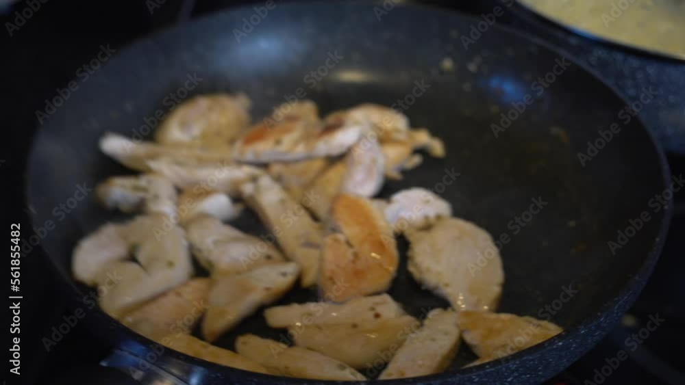 Fried chicken, stir-fried spicy chicken breast. The chicken looks Spicy fried and delicious. Man shaking the pan Fried chicken, stir-fried spicy chicken breast. The chicken looks Spicy fried and delicious. Man shaking the pan