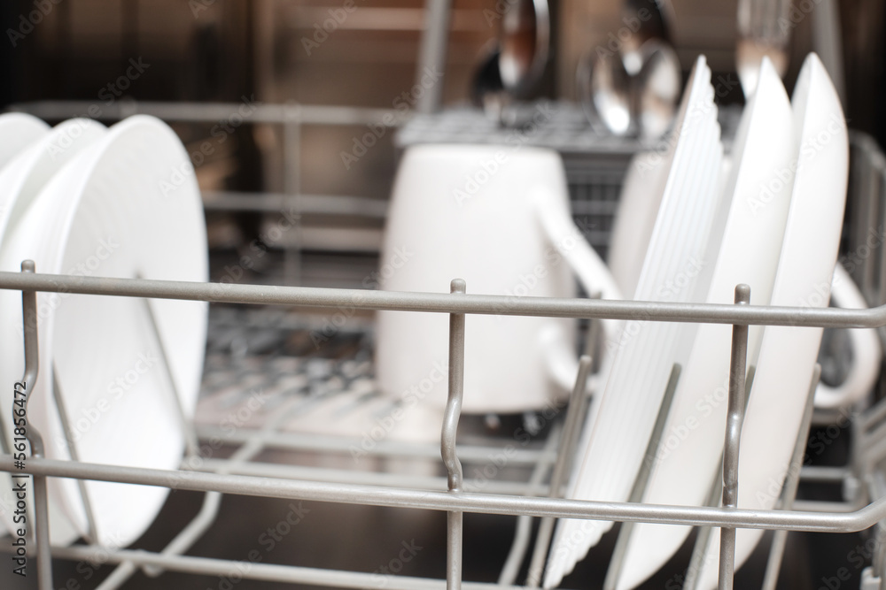 Fototapeta premium Clean dishes are in the dishwasher. The concept of cleaning dirty dishes and glasses