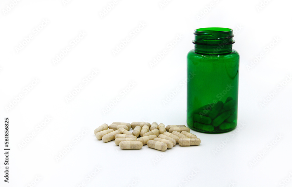 White pills or capsule with green pill bottle isolated on white background with copy space for add text. Healthy, herb, container object and Medicine. Food supplement for cure or repair health White pills or capsule with green pill bottle isolated on white background with copy space for add text. Healthy, herb, container object and Medicine. Food supplement for cure or repair health