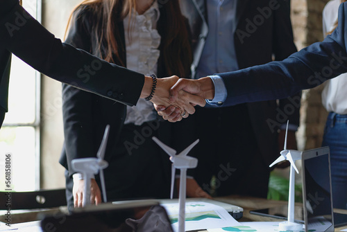 Business Partnership and Renewable Energy - Close-up of a hand shake between a man and a woman in a business setting