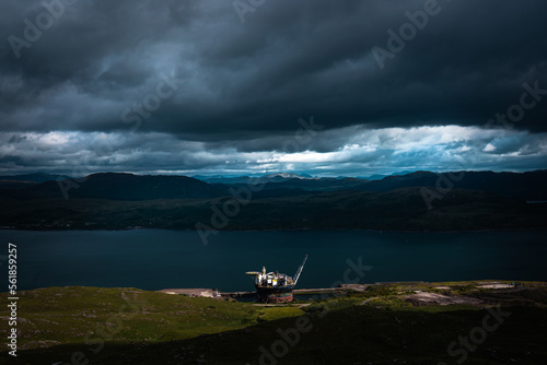 lake in the mountains with an oil rig