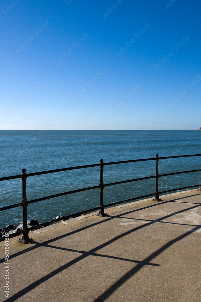 Railings,sunshine,blue sky and sea, simple graphic composition.