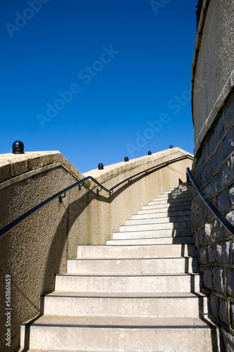 Stairway to heaven. Curved steps going up towards a blue sky.