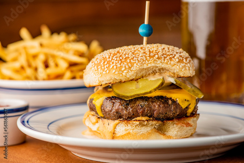 Hamburger. Bacon Cheeseburger. Classic traditional American bar, restaurant entree. Beef hamburger with Swiss and cheddar cheeses served with lettuce, tomato, onion and hand cut french fries. 