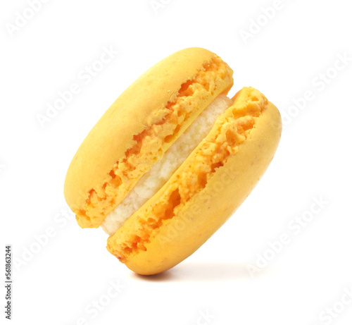 Popular French cake closed up isolated on white. Yellow citron macaroon with cream filling are flying.