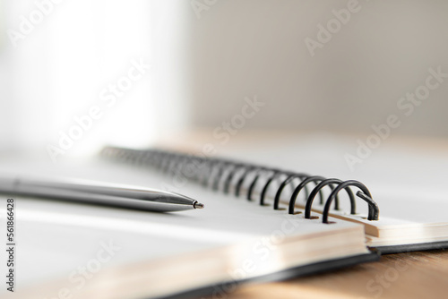 notebook and pen close up with a blurred background in the foreground