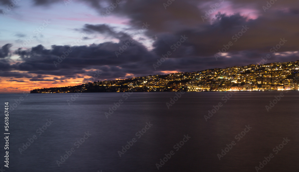 Panoramic sunset view of Naples waterfront, Italy.