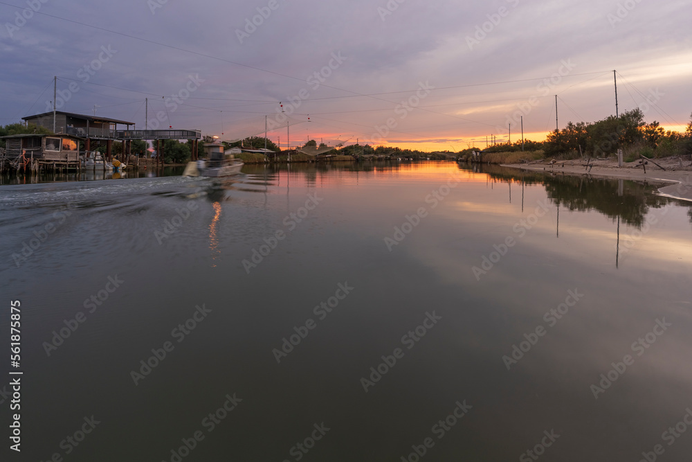 Fototapeta premium Nice view of fishing huts on river at sunset,italian fishing machine, called 