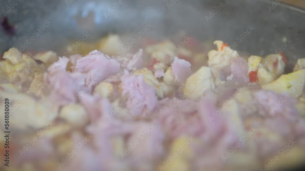 Homemade chiken dish, frying chiken with carrot and vegetables in a pan with sunflower oil Homemade chiken dish, frying chiken with carrot and vegetables in a pan with sunflower oil