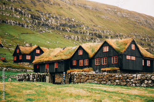 Typical wooden houses with a grassy roof in the Faroe islands photo