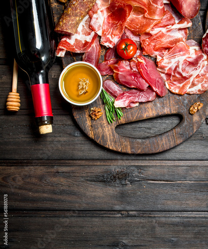 Antipasto background. Different meat snacks with red wine.