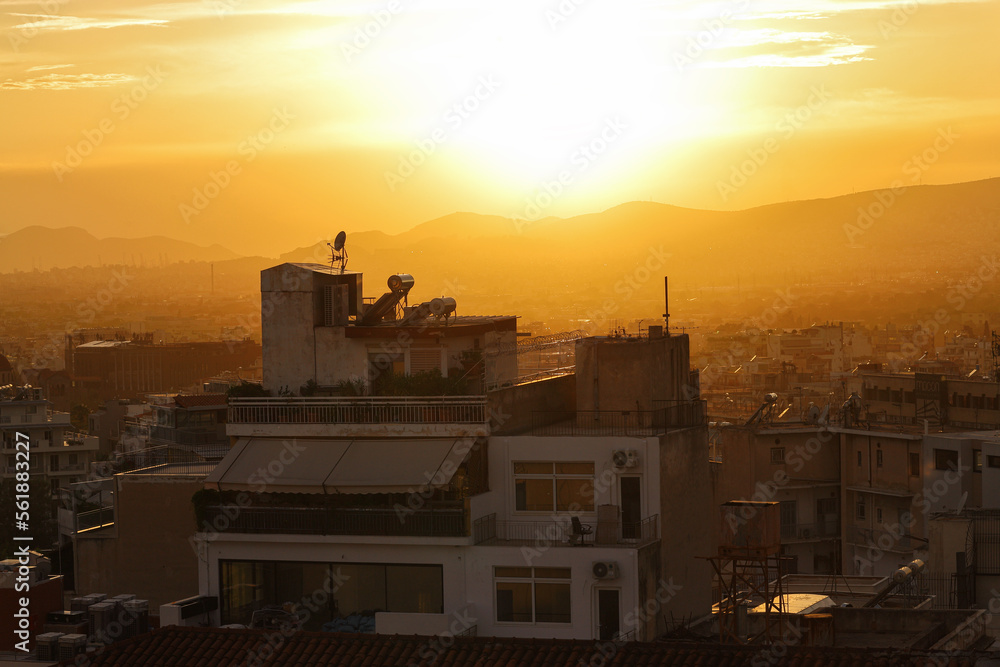 Rooftops of Greek capital Athens in the evening at sunset. Cityscape, rooftops and mountains. Greece, Southern Europe, travel destination, vacation, urban landscape, metropolis.