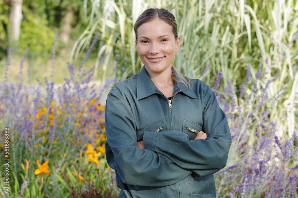Fototapeta premium young happy woman working in her greenhouse