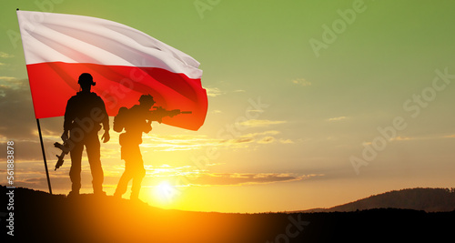 Silhouettes of soldiers with national flag on background of sunset. Polish Armed Forces. Armed Forces of the Republic of Poland. Polish army.